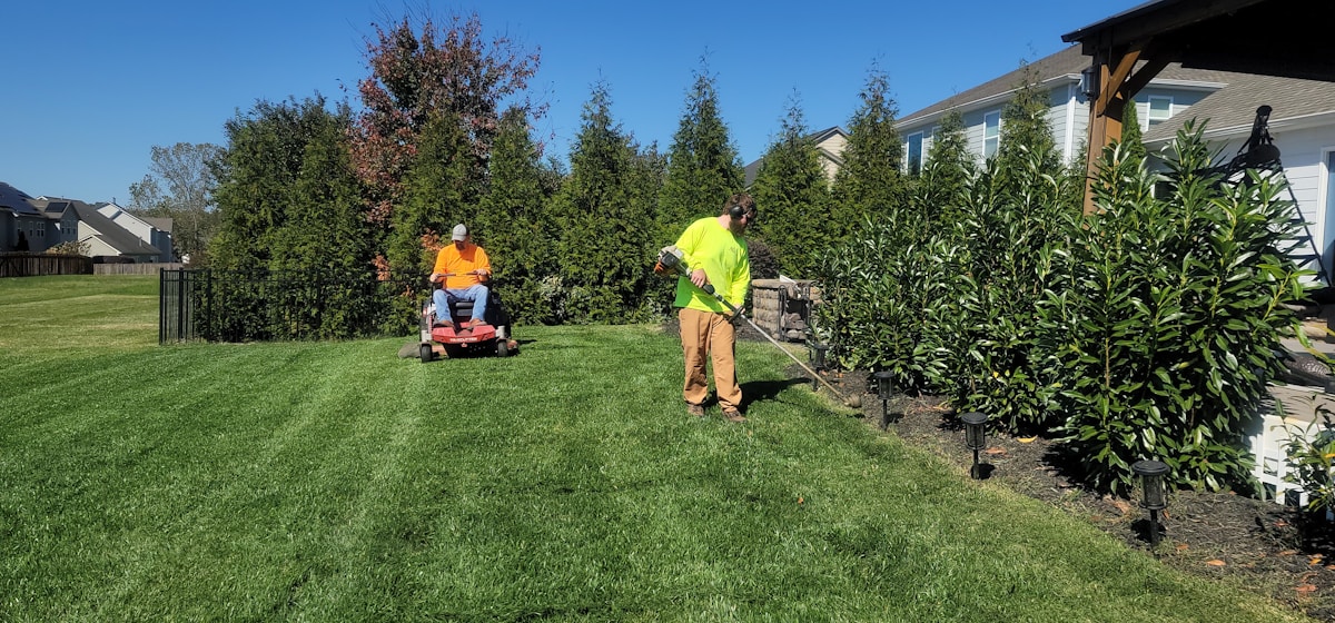 Landscaping crew maintaining a lawn